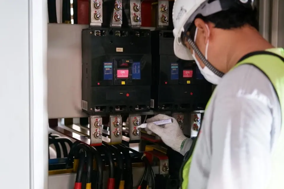 Close-Up Photo of a Man Checking a Power Voltage