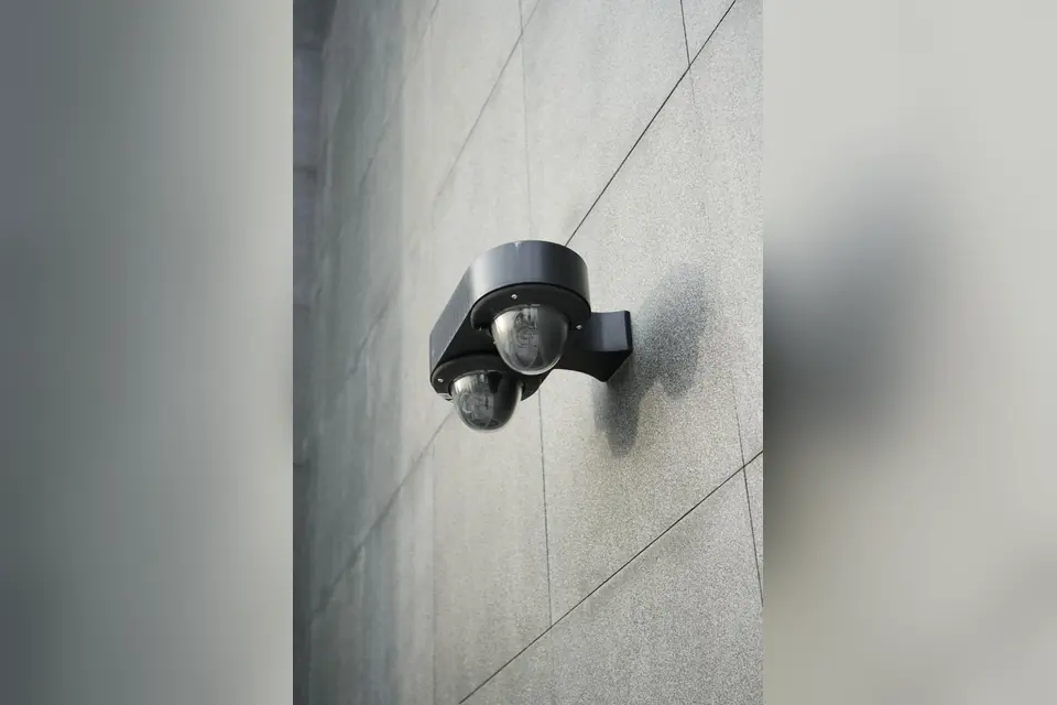 Black Motion Sensor on Gray Wall