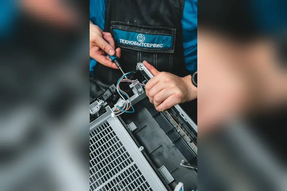 Technician Repairing Electronic Device with Tools