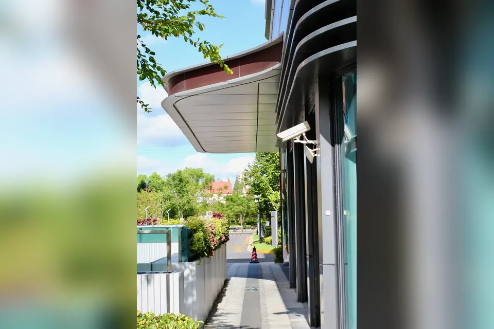 Modern Building Facade with CCTV on a Sunny Day