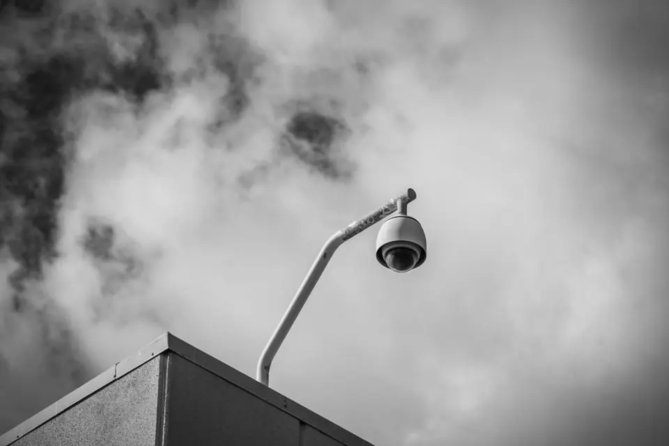 Monochrome Security Camera on Building Corner