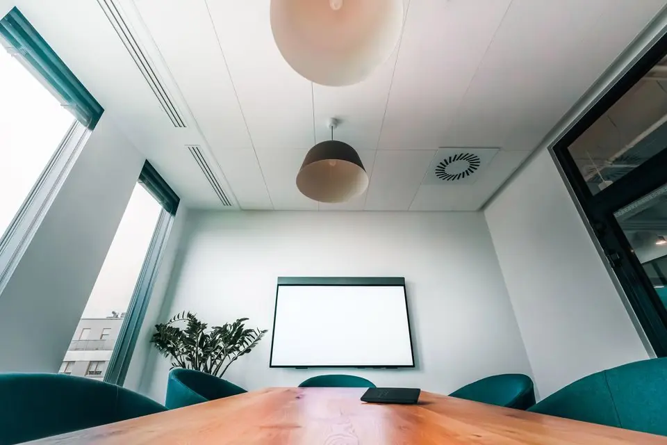 Modern Conference Room with Blank Screen