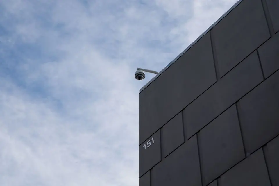 Security Camera Hanging on Top of a Building