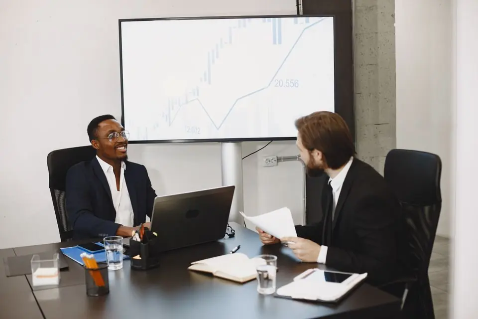 Businessmen Talking in Conference Room