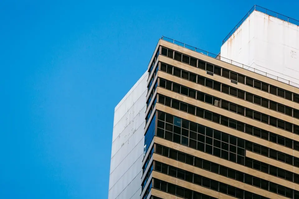 Facade of multistory commercial building against cloudless blue sky